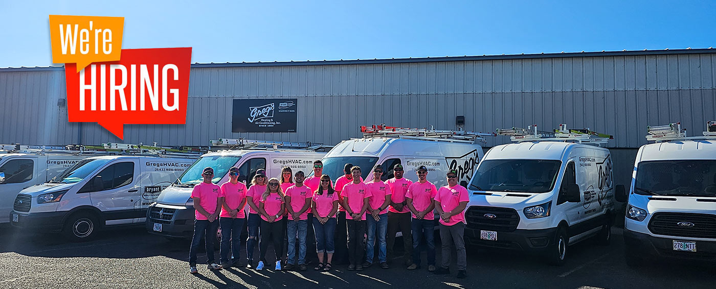 Greg's HVAC Staff in front of their shop and fleet of vehicles with a We're Hiring sign.